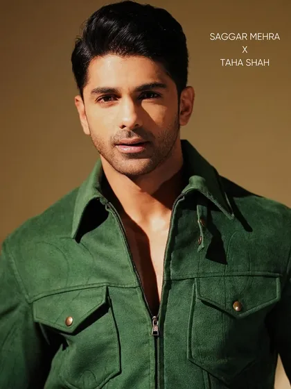 A direct, confident portrait of Taaha Shah in the green jacket. The rich color and precision tailoring make it a versatile piece that commands attention.