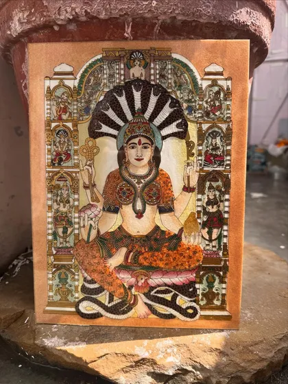 This artwork of Goddess Padmavathi is a celebration of grace, prosperity, and intricate detail. Each semi-precious stone is set by hand to capture her celestial radiance and the abundant blessings she represents, making it a source of wealth and peace.