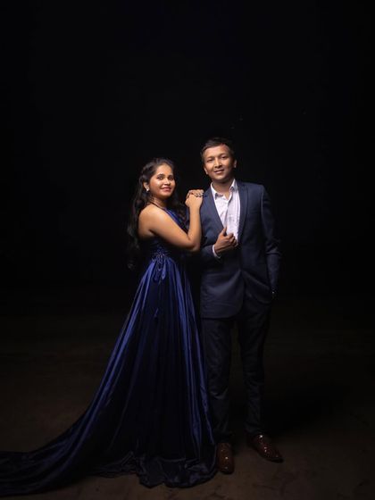 A classic and elegant portrait against a pure black background, showcasing the couple's formal attire and creating a timeless look.