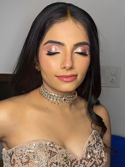 An eyes-closed shot to showcase the shimmery pink and rose-gold eyeshadow.