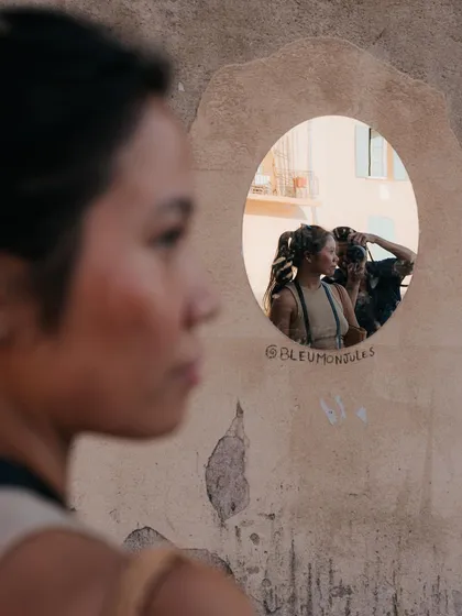 A quiet moment captured in St Tropez. The reflection in the mirror adds a layer to the portrait, creating a more documentary-style travel photograph.