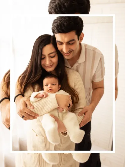 A classic family portrait with new parents holding their baby. We use soft, natural light in our studio to create a warm and inviting atmosphere.