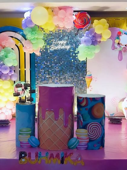 A wider view of the candy land theme, showing the custom-printed pedestals and the full arrangement of sweet treat props.