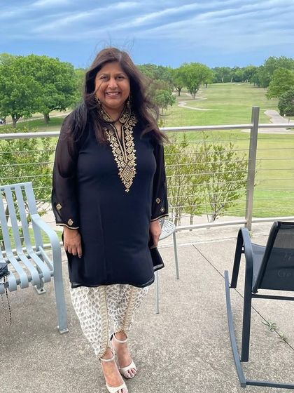 A happy client looking chic in a black embroidered kurti paired with printed dhoti pants. A perfect semi-formal look.