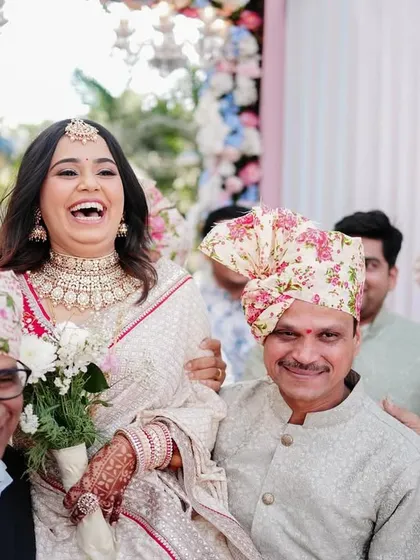 The bride's grand entrance, carried by her laughing family members. This shot is full of energy, tradition, and the joyous spirit of an Indian wedding.