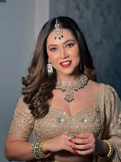 My bride Mansi, looking radiant for her reception with a bold red lip and glamorous makeup.
