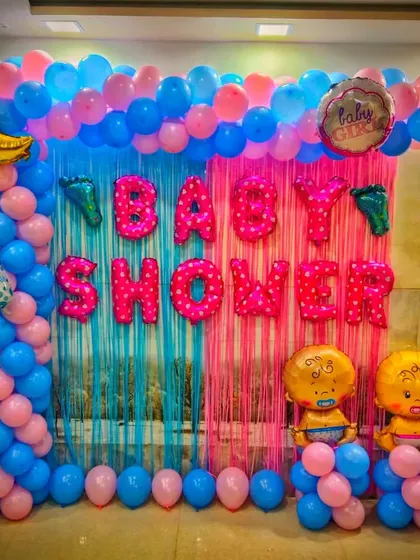 A full view of the pink and blue themed baby shower backdrop. The split-color design is a popular choice for gender reveals or showers where the theme is simply 'baby', and the foil letters make the occasion clear.