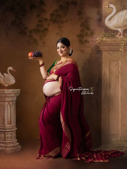 A beautiful composition showing the baby bump, with the mother holding a platter of fruit, symbolizing abundance.