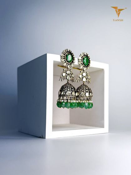 These traditional kundan jhumkas are handcrafted with uncut diamonds and emeralds, where timeless design meets precision craftsmanship.