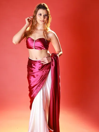 This pose showcases the unique drape of the saree and the pearl-bordered tube blouse. It's a great example of a modern, creative take on ethnic wear.