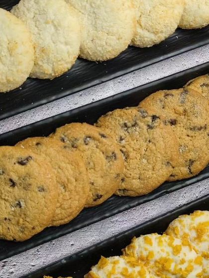 A close-up of coconut macaroons, choco-chip cookies, and cornflake cookies from our cookie class.