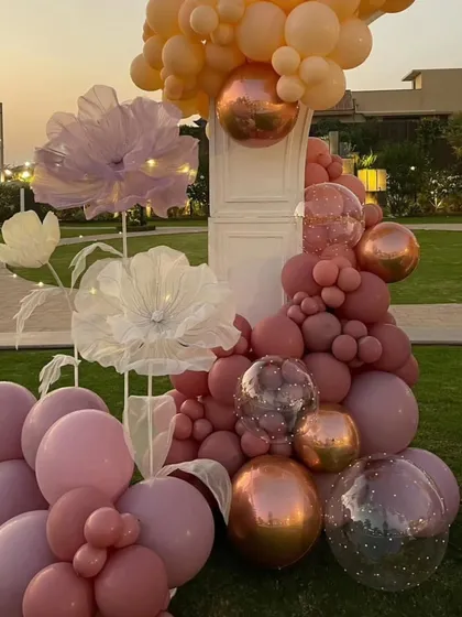 A detailed shot of the custom balloon and flower installation, showcasing the blend of textures and soft pastel colors.