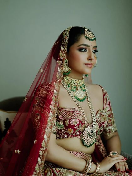 For this bride, we balanced enchanting kohl-rimmed eyes with a soft, captivating lip color. Her look is a perfect example of how to blend traditional elements with modern bridal beauty.