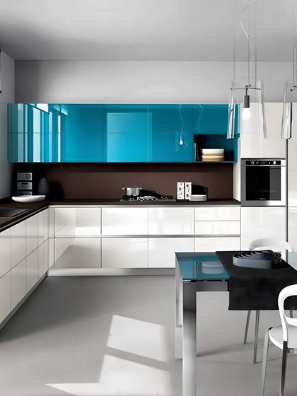 A high-end modern kitchen with glossy white and bold blue lacquered cabinets. This design is perfect for an open-plan space with an attached dining area.