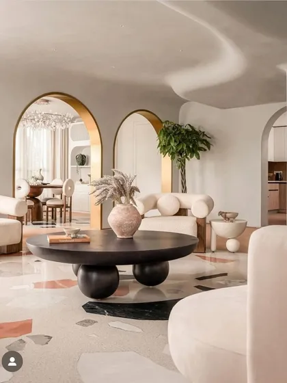 The living room of the "Marshmallow" penthouse, with its curved sofas and brass-lined arches, featured by FOAID.