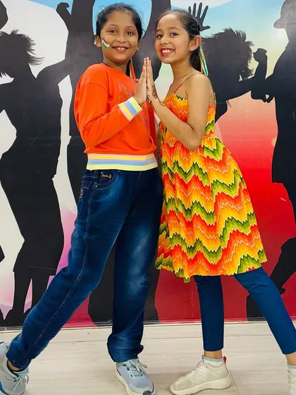 A respectful 'namaste' pose from our students, dressed in vibrant outfits for the Independence Day performance.