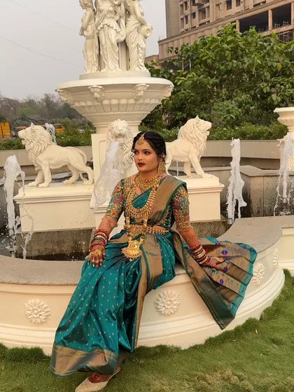 Another beautiful shot of the bride by the fountain, showcasing her complete look.