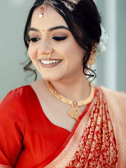 A close-up on the bride's soft glam makeup, with defined eyes and a neutral lip color.