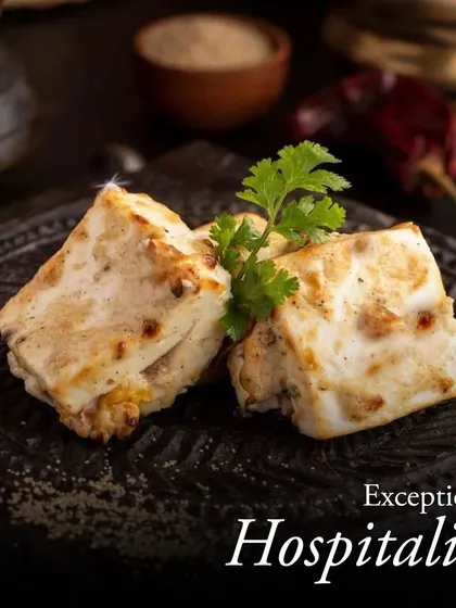 We pair exceptional hospitality with authentic Indian flavors. These succulent pieces of Paneer Malai Tikka, garnished with fresh cilantro, showcase the warmth and care in every dish we serve.