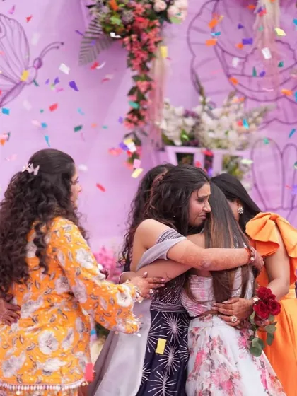 A heartfelt group hug among friends at the carnival. These are the emotional, candid moments that make a wedding special.