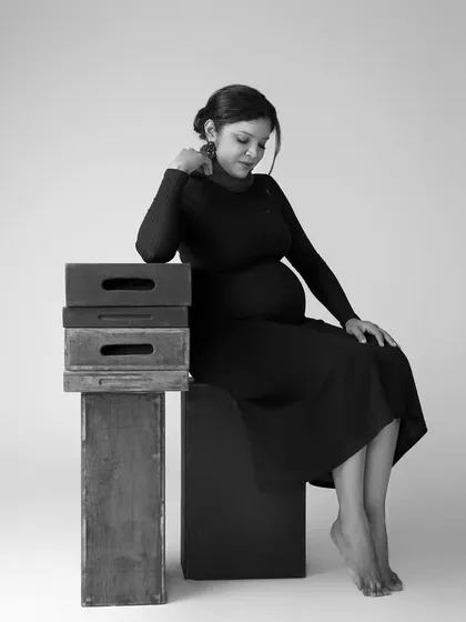 A pensive and beautiful solo portrait. Using simple props like these wooden boxes adds a touch of rustic charm to this elegant black and white shot.