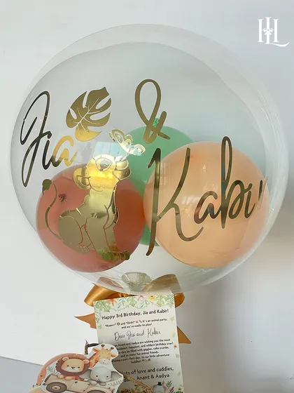 The custom balloon for the 3rd birthday hamper, featuring the children's names and a golden Simba illustration.