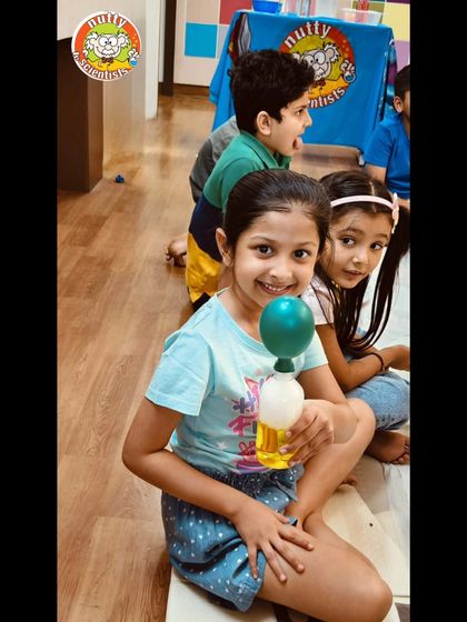 The joy of a successful experiment. This self-inflating balloon trick, using a simple acid-base reaction, always brings a smile to our young scientists' faces.