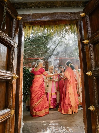 A traditional welcome ceremony at the entrance, with elders blessing the groom as he arrives.