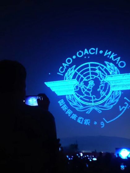 An audience member captures our aerial display of the International Civil Aviation Organization (ICAO) logo. This was one of the five world records we broke for the largest aerial logo formation.