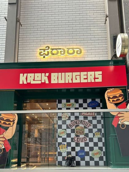 The exterior view of the Krok Burgers launch, showcasing the complete storefront branding and character cutouts we produced. Our work helps create a buzz and attract customers from the very first glance.