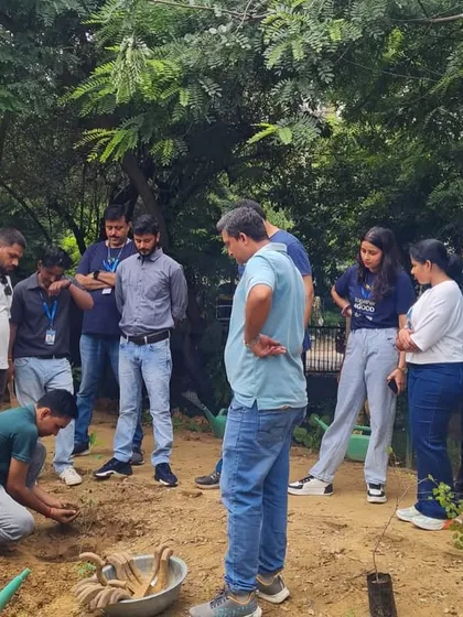 Our on-ground team demonstrates the correct planting technique to volunteers from NTT DATA. This knowledge sharing is a key part of our collaborative drives, ensuring every sapling has the best chance of survival.