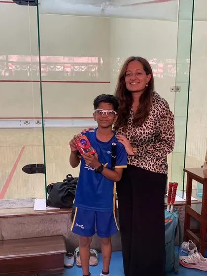 A young player from the Squash Star Academy tournament proudly shows off his prize.