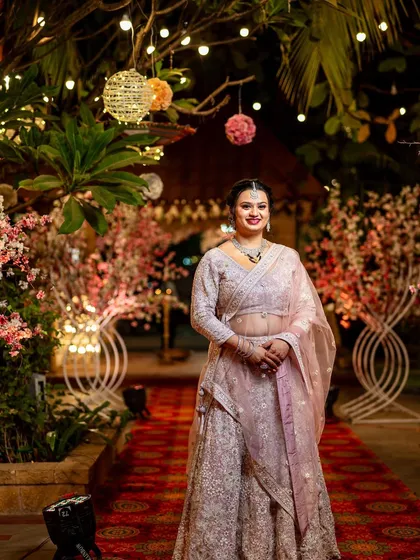 The bride, looking radiant and graceful in her pink lehenga, ready to celebrate her reception.