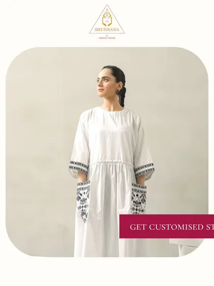 An elegant white dress with embroidered pockets and cuffs. I specialize in customized stitching and styling that brings your fashion dreams to life.