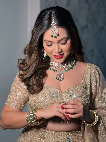 A candid moment of Mansi, her red nails perfectly matching her lipstick.