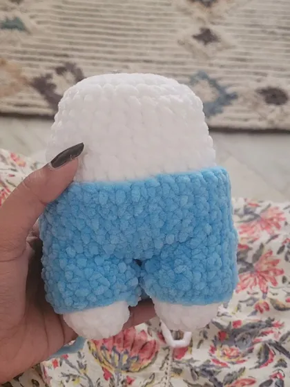 A progress shot showing the bottom half of the Fluffy bunny, with the blue overalls attached to the white body.