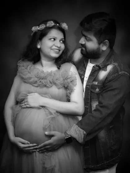 A classic black and white portrait of the expecting couple. This timeless style focuses on their connection and the quiet joy of this special time.