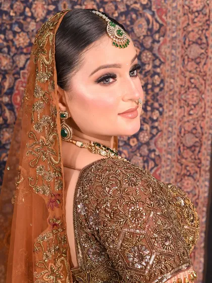 A side profile that highlights the glowing skin and expertly blended contour. The shimmer on the cheekbones catches the light perfectly, showing how HD makeup looks incredible from every angle.