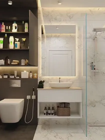 A bright and practical bathroom design combining dark and marble-look tiles. We included ample storage with both open and closed shelving above the toilet and under the sink.