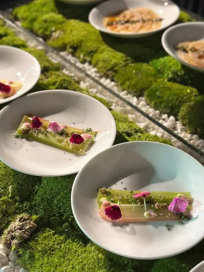 An elegant appetizer of steamed celery root with edible flowers, served on a bed of moss. This dish showcases our commitment to artistic presentation and using unique ingredients.