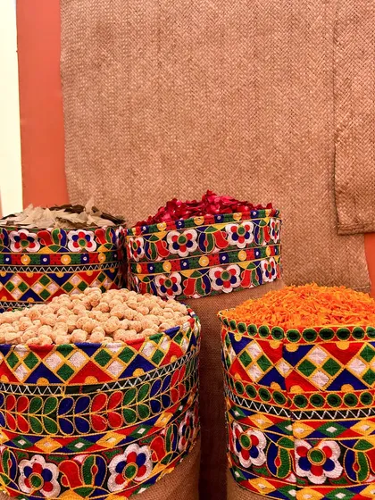 A close-up of burlap sacks topped with colorful embroidered fabric, filled with grains and spices. It's these small, authentic details that make our themes stand out.