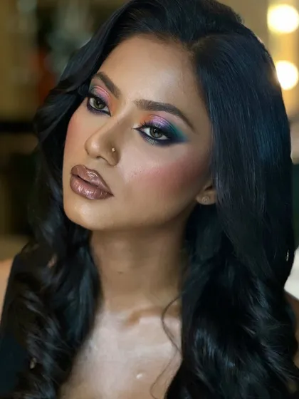 Melanin kissed by the sun, glowing like royalty. This image showcases a vibrant, colorful eye look on a beautiful dusky skin tone.