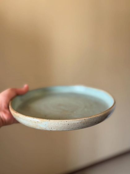 Another angle of the Chun dinner plate, showing the slight variations in the glaze that make every handmade piece unique.