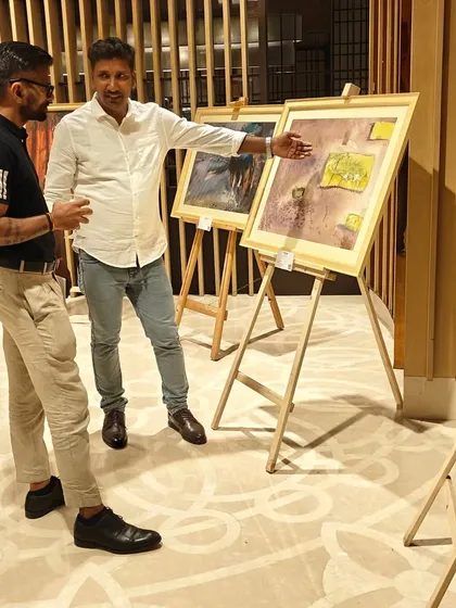 An artist in his element, sharing the story behind his work with an engaged guest at our 'Ethereal Charm' exhibition. We foster these connections, creating soirees where collectors can meet the creators and truly understand the art.