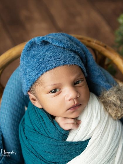 A captivating portrait of an awake newborn making direct eye contact. His curious expression is simply priceless.