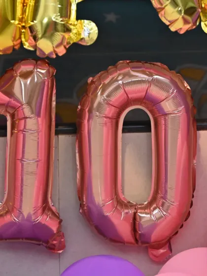 Close-up of the number '10' foil balloons for the birthday celebration.