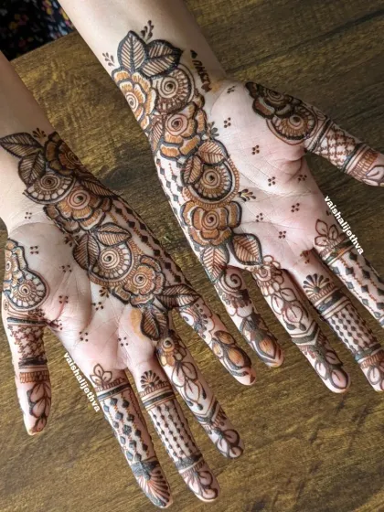 A modern floral design with an open, airy feel. The pattern flows diagonally across the hands, creating a graceful and contemporary look.