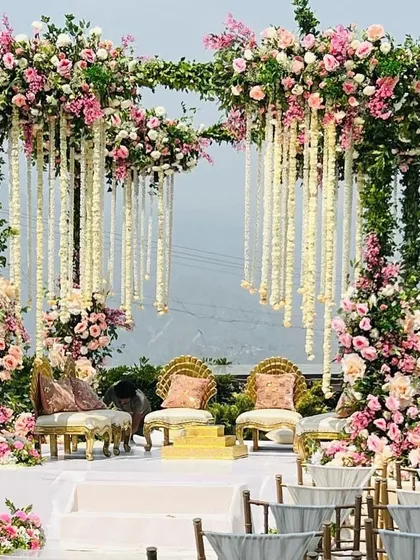 This mandap is a floral masterpiece, featuring cascading white kaleeras and an abundance of pink and white roses. It’s an incredibly romantic and luxurious choice for a day wedding.