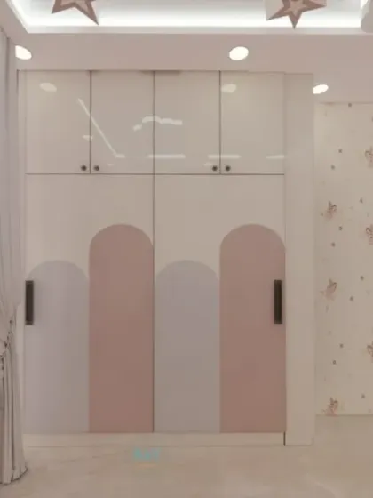 The wardrobe in the pink kids' room, featuring a modern design with arched pink panels.