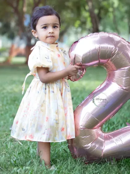 Turning two is such a fun age to capture. This little one is proudly holding her number '2' balloon during her outdoor birthday photoshoot in a lovely Navi Mumbai park.